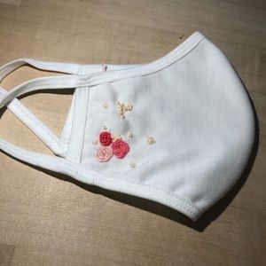 Hand embroidered face mask.